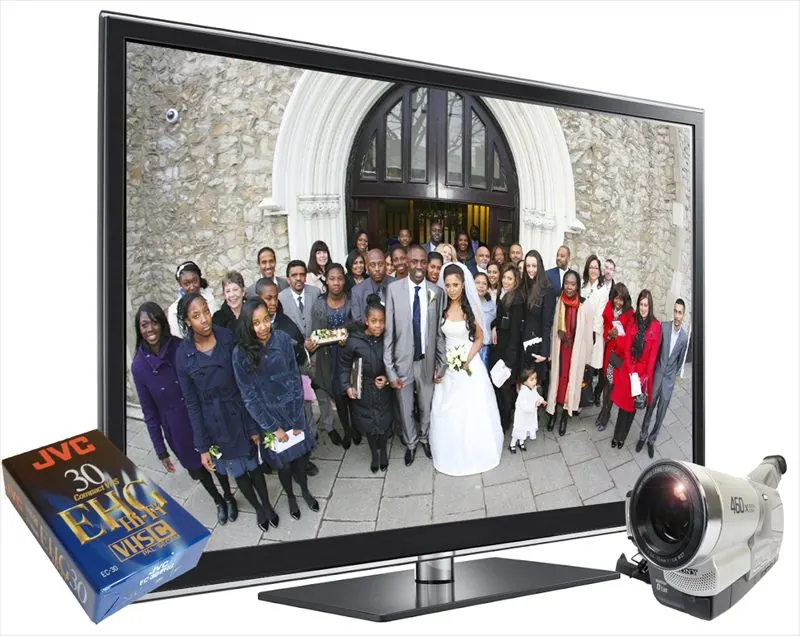 Wedding video displayed on a television beside a VHS tape and camcorder